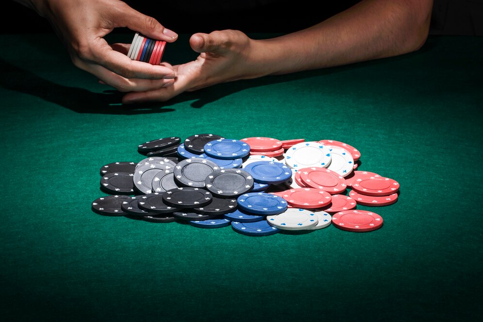 different-poker-chips-casino-table_23-2147881549